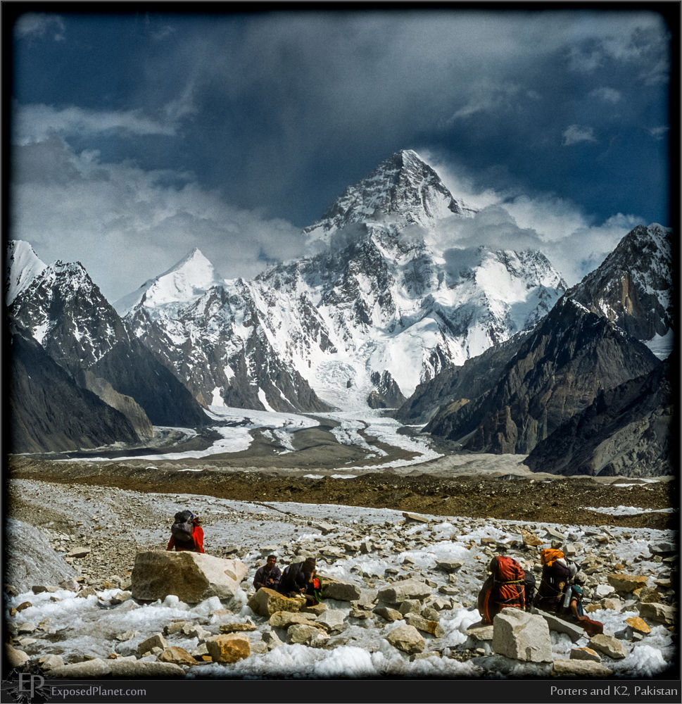 Porters on Baltoro Glacier with K2 in back