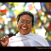 Happy Woman in Kathmandu with prayer flags