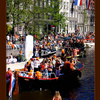 Orange boats in the Amsterdam canals at Queensday
