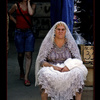 Russian lady selling woolen scarves on the market