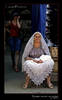 Russian lady selling woolen scarves on the market